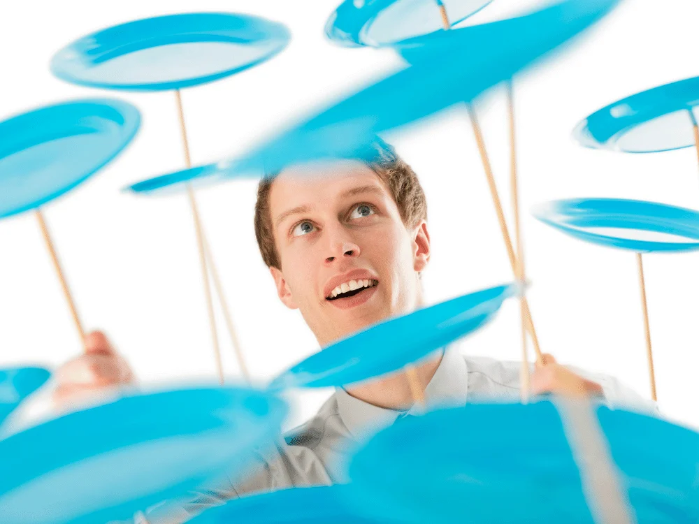 A teacher spinning dozens of blue plates on sticks at an awful professional development course.