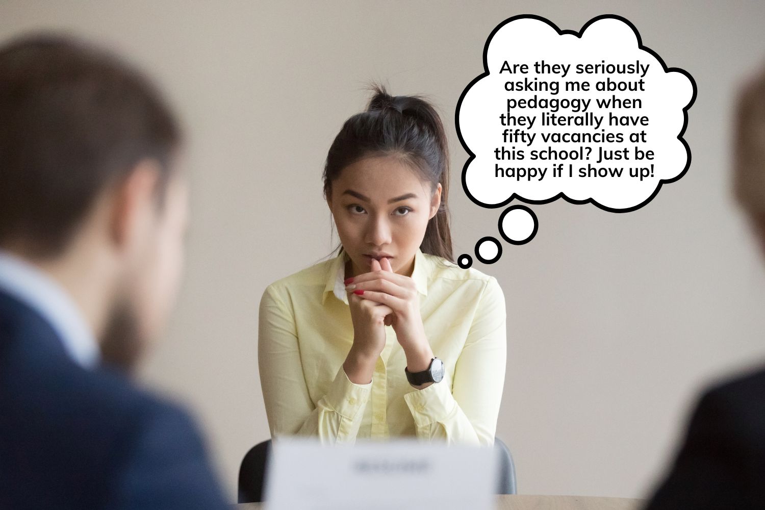 A woman interviewing for a teaching job looks exasperated by the exhaustive questions from a poorly run administration.
