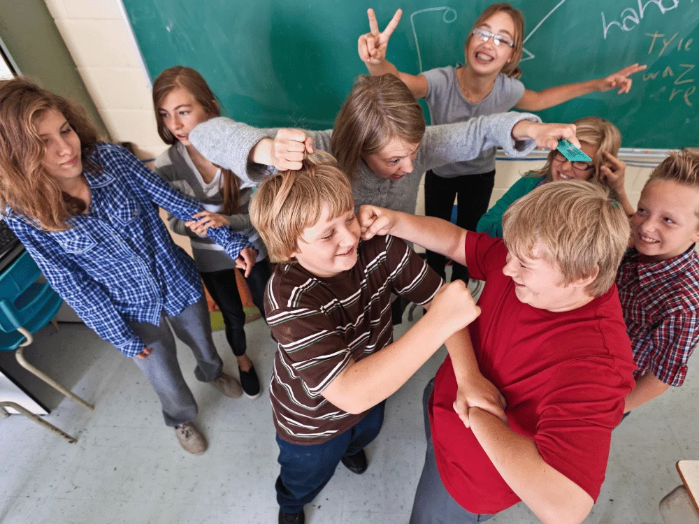 Students wrestling in a classroom.