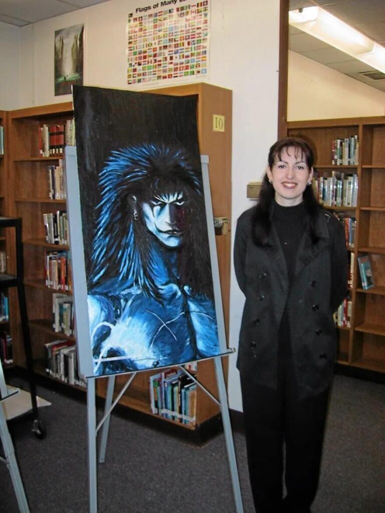 Bullied high School art teacher Jennifer Lenihan pictured with her artwork before her death.