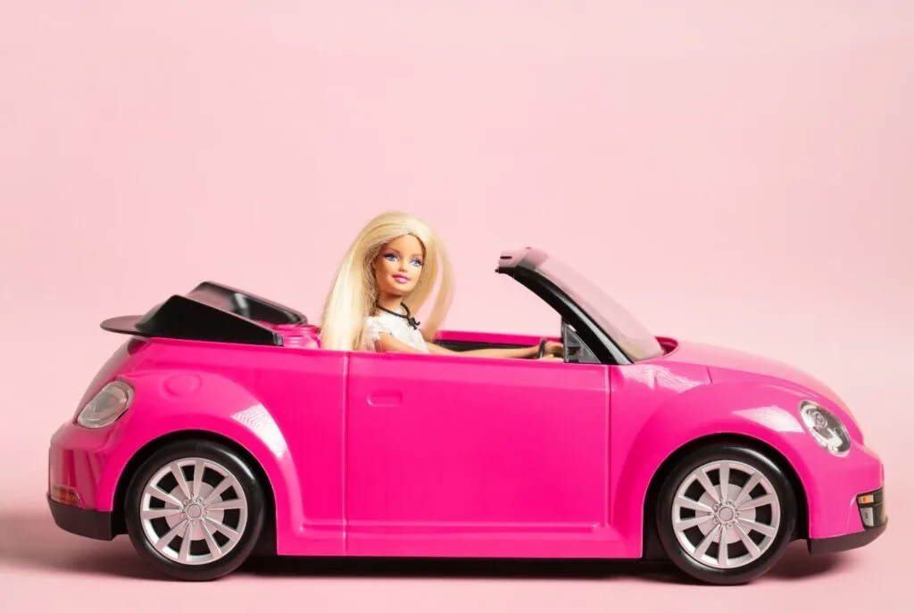 Barbie driving a pink car much like the little girl in the funny student story.