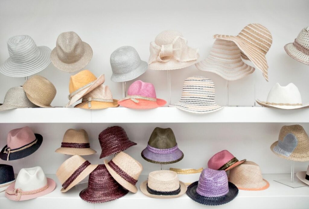 An array of different hats in a closet representing the many roles a teacher and educational consultant plays.