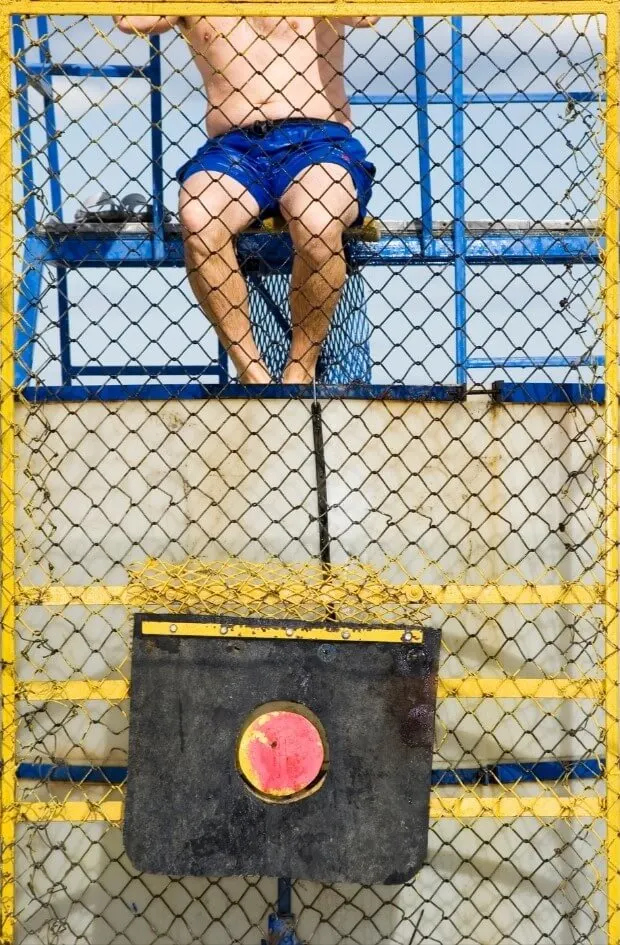 A teacher sits in a dunk tank at a terrible school fundraiser.