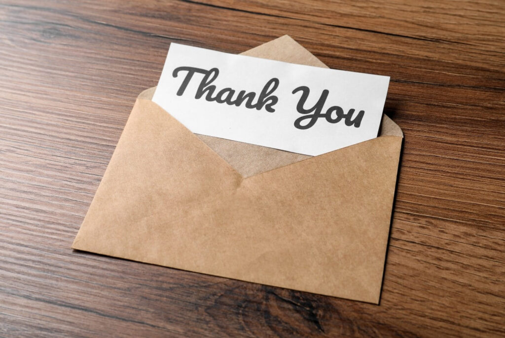 An appreciation letter to a teacher in a brown envelope reading "Thank You".